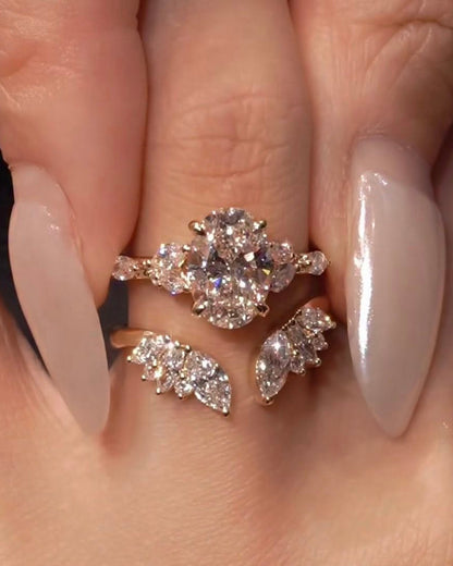 Close-up of a hand wearing two diamond rings with a neutral background